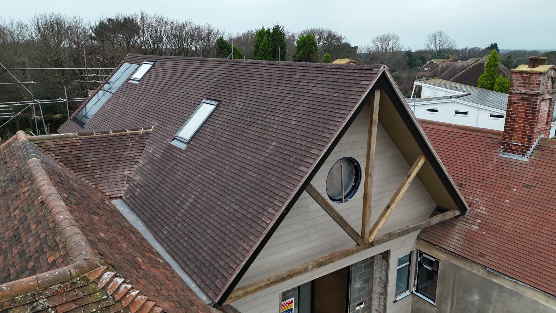 New brown tiled roof with skylights and gable detail